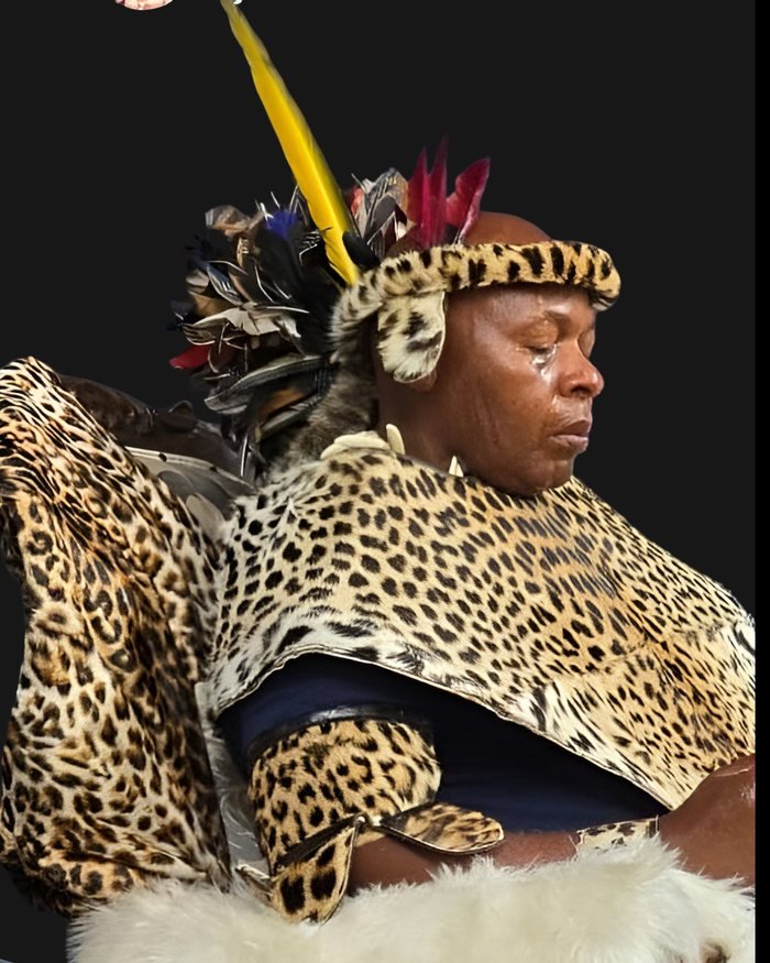 Nkosi Xhel'indlovu seated in leopard-skin attire with a feather plume